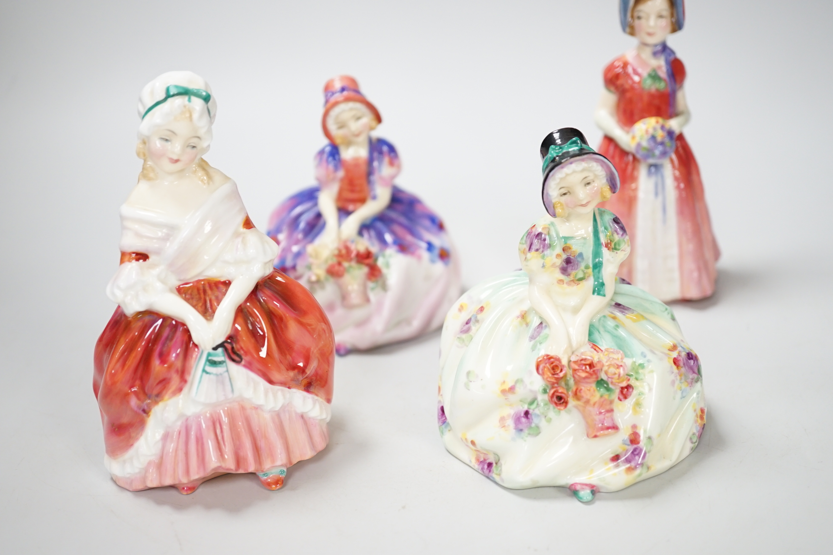 Four Royal Doulton figurines, including Monica HN 1458 and Monica NN 1467